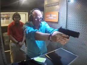 A screengrab from a video showing Conservative leadership candidate Kevin O'Leary firing weapons at a shooting range.