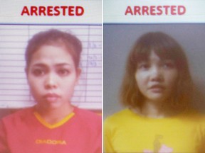 Photos released by the Royal Malaysia Police, showing Indonesian suspect Siti Aisyah, left, and Vietnamese suspect Doan Thi Huong, are displayed on a screen during a press conference about the murder of Kim Jong Nam