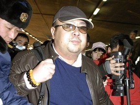 A man believed to be Kim Jong-nam is surrounded by the media as he arrives at the Beijing airport on Feb. 11, 2007.