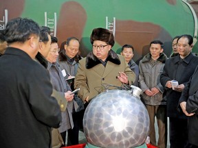 An undated picture provided on 09 March 2016 shows North Korean leader Kim Jong-un (C), talking with scientists and technicians involved in research of nuclear weapons, at an undisclosed location, North Korea.