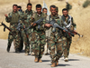 Iraqi Kurdish Peshmerga fighters march near Mosul in October 2016.