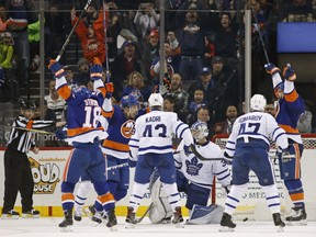 Andrew Ladd, right, of the New York Islanders celebrates his game-tying goal with less than a minute remaining against Toronto Maple Leafs' goaltender Frederik Andersen during NHL action Monday in Brooklyn, N.Y. The Islanders went on to win the game 6-5 in overtime.