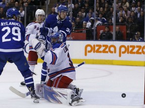 Toronto Maple Leafs' William Nylander deflects the puck past New York Rangers' goaltender Henrik Lundqvist during NHL action Thursday in Toronto. The puck dribbled wide. Lundqvist was a standout with 30 saves as the Rangers posted a 2-1 win in a shootout.