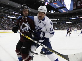 Brian Boyle, right, checks Colorado Avalanche defenceman Mark Barberio on Feb. 19. The Toronto Maple Leafs acquired Boyle from the Tampa Bay Lightning on Feb. 27.