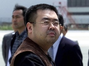 In this May 4, 2001, file photo, a man believed to be Kim Jong Nam looks at a battery of photographers