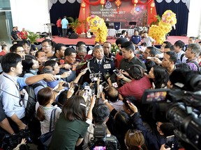 Malaysia's National Police Inspector-General Khalid Abu Bakar, center, is surrounded by journalists in Kuala Lumpur, Malaysia, Thursday, Feb. 23, 2017.