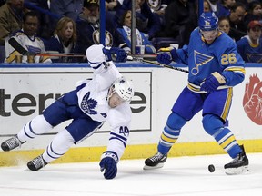 Toronto Maple Leafs defenceman Morgan Rielly, left, falls as St. Louis Blues forward Paul Stastny keeps his eyes on the puck on Feb. 2.