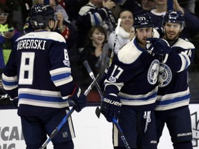 Boone Jenner, right, celebrates his goal against the Toronto Maple Leafs with Blue Jackets teammates Zach Werenski and Brandon Dubinsky during the first period of their game in Columbus, Ohio, on Wednesday night. The Blue Jackets won 5-2.