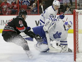 Carolina Hurricanes' Joakim Nordstrom is blocked by Toronto Maple Leafs goalie Curtis McElhinney and Nikita Zaitsev during the second period in Raleigh, N.C., Sunday. Toronto won 4-0.