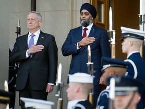U.S. Defense Secretary Jim Mattis and Canadian Defense Minister Harjit Sajjan stand for the U.S. national anthem at the Pentagon, Monday, Feb. 6, 2017.