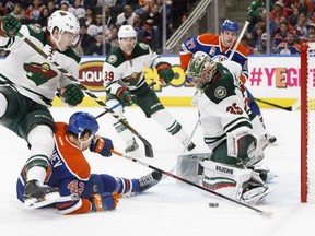 Darcy Kuemper of the Minnesota Wild makes one of his 41 saves as he denies Edmonton Oilers' Anton Slepyshev with help from defenceman Mike Reilly during NHL action Tuesday night in Edmonton. With Kuemper leading the way, the Wild was a 5-2 winner, giving them their third win in as many starts against the Oilers this season.