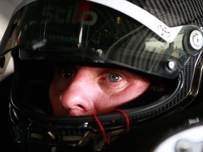 D.J. Kennington sits in his car during practice for the 59th Daytona 500 on Feb. 18.