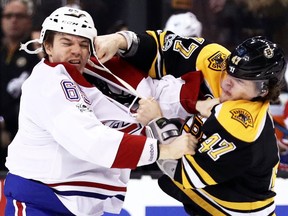 Boston Bruins defenceman Torey Krug (right) punches Montreal Canadiens forward Andrew Shaw on Feb. 12.