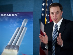 SpaceX CEO Elon Musk unveils the Falcon Heavy rocket at the National Press Club in Washington,DC on April 5, 2011. The rocket will fly two people to the moon in 2018, Musk said.