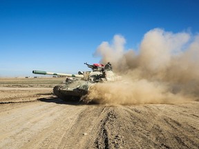 Tanks and armoured vehicles of the Iraqi forces, supported by the Hashed al-Shaabi paramilitaries, advance towards the village of Sheikh Younis, south of Mosul, after the offensive to retake the western side of Mosul from ISIL commenced on Feb. 19, 2017.