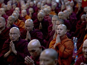 In this June 27, 2013 photo, controversial Buddhist monk Wirathu, second right foreground, who is accused of instigating sectarian violence between Buddhists and Muslims through his sermons, performs Buddhist rituals with Myanmarís powerful Buddhist clergy in outskirts of Yangon, Myanmar. As the predominantly Buddhist nation of 50 million started transitioning from dictatorship toward democracy in 2011, the rise in radical Buddhist nationalism has taking advantage of the newfound freedoms of expression to fan prejudices against the long-persecuted Rohingya Muslim minority.