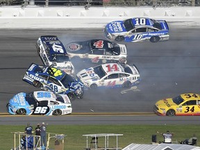 D.J. Kennington (96) is caught in a 16-car collision at the Daytona 500 on Feb. 26.