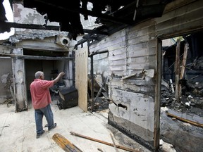 In a Thursday, Sept. 15, 2016, file photo, Farhad Khan, who has attended the Islamic Center of Fort Pierce for more than seven years, shows members of the media its charred remains, in Fort Pierce, Fla.