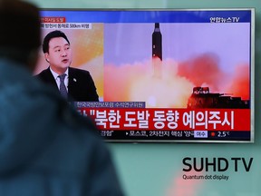 A man watches a television screen showing a news broadcast on North Korea's unidentified ballistic missile launch at Seoul Station in South Korea, on Sunday, Feb. 12, 2017.