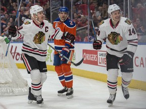 Jonathan Toews, left, and Richard Panik of the Chicago Blackhawks celebrate a first period goal against the Oilers at Rogers Place in Edmonton on Saturday night.
