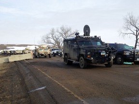 Law enforcement vehicles arrive at the closed Dakota Access pipeline protest camp near Cannon Ball, N.D., Thursday, Feb. 23, 2017