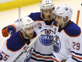 Oscar Klefbom (77) and Leon Draisaitl (29) congratulate Oilers teammate Mark Letestu after his goal against the Blues during the second period of their game, Tuesday night in St. Louis.