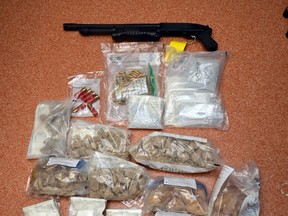 Some of the drugs and a gun seized by Ontario Provincial Police in a massive bust announed Feb. 23.