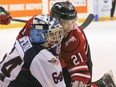 In this Jan. 7 file photo, the Owen Sound Attack's Jonah Gadjovich (right) collides cheek to cheek with Windsor Spitfires goalie Michael DiPietro during Ontario Hockey League action.