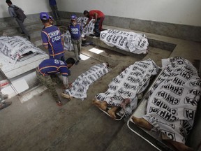 Bodies of alleged militants killed in an operation by security forces are tended to by workers from the Chhipa Welfare Association, at a mortuary, in Karachi, Pakistan, Wednesday, Feb. 22, 2017. Rao Anwar, a police official in Karachi, said eight Taliban-linked militants were killed in the raid.