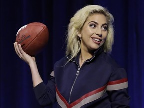 Lady Gaga holds a football at a news conference before Super Bowl LI in Houston on Feb. 2.