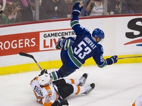 The Vancouver Canucks Bo Horvat, battles the Philadelphia Flyers in Roger's Arena in Vancouver on Sunday.