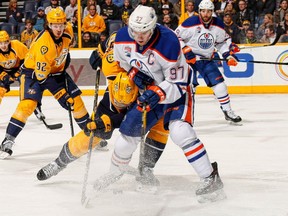 Edmonton Oilers' captain Connor McDavid gets all tangled up with a member of the Nashville Predators during NHL action Thursday night in Nashville. It was this way most of the night as the Preds prevailed 2-0, sending the Oilers to their second straight defeat coming out of the all-star break.