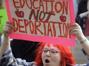 Demonstrators hold a rally Monday, Feb. 20, 2017, in Salt Lake City. The rally is one of several Not My Presidents Day protests planned across the country to mark the Presidents Day holiday. Protesters are criticizing President Donald Trump's immigration policies, among other things. (AP Photo/Rick Bowmer)