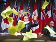 Former Attorney General of Ontario Michael Bryant  throws up copies of parking tickets at the end of a press conference at Queen's Park with the Coalition to Repeal Safe Streets Act in Toronto, Ont. on Monday December 15, 2014.