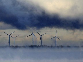 Steam from the water and clouds in the sky frame the wind turbines on Wolfe Island on Tuesday, Jan. 5, 2015.