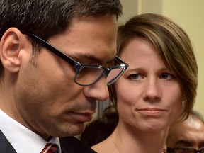 Former Quebec government House Leader Gerry Sklavounos speaks to media as wife Janneke looks on during a news conference, in Montreal on Thursday, February 9. Sklavounos, a member of the Quebec national assembly who was booted out of the Liberal caucus for alleged sexual improprieties says he will return to the legislature next week.