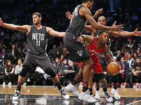 Toronto Raptors guard Kyle Lowry (right) dribbles between three Brooklyn Nets defenders on Feb. 5.