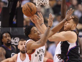 Toronto Raptors' DeMar DeRozan, left, battles Blake Griffin of the Los Angeles Clippers during NBA action Momday night in Toronto. DeRozen returned to the Raptors' lineup in a big way with 31 points as they posted a 118-109 victory at the Air Canada Centre.