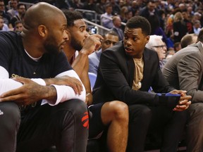 Raptors guard Kyle Lowry (right) wears a wrist guard on the bench during Toronto's Feb. 24 game against the Boston Celtics.