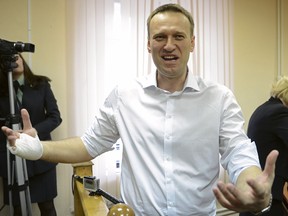 Russian opposition leader Alexey Navalny speaks to journalists after a trial in Kirov, Russia, Wednesday, April 17, 2013. The trial of Navalny accused of embezzling half a million dollars' worth of timber from a state-run company was adjourned shortly after its start Wednesday in the northwestern city.