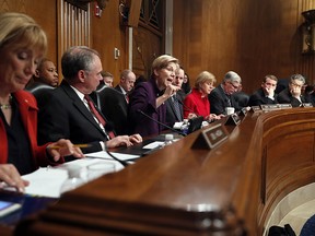 Senate Health, Education, Labor, and Pensions Committee member Sen. Elizabeth Warren, D-Mass., third from left, speaks on Capitol Hill in Washington, Tuesday, Jan. 31, 2017