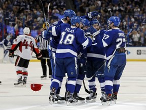 Members of the Tampa Bay Lightning, including Ondrej Palat and Jonathan Drouin congratulate Nikita Kucherov, centre, on his third goal of the second period against the Ottawa Senators on Monday in Tampa.