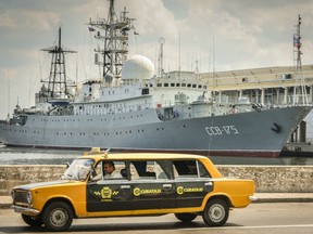A  Soviet-made Lada limousine passes by the Viktor Leonov, docked in Havana, in 2014. The spy ship has been sailing along the U.S. Eastern Seaboard recently.