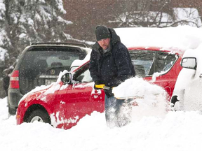 Ronald Lavis digs out a car in the Montreal suburb of Saint-Laurent on Monday after up to 23 centimetres of snow fell in some parts of the city.