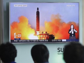 In this June 23, 2016, file photo, people watch a TV news channel airing an image of North Korea's ballistic missile launch published in North Korea's Rodong Sinmun newspaper at the Seoul Railway Station in Seoul, South Korea.