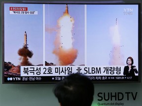 A man watches a TV news program showing photos of the missile launch and North Korean leader Kim Jong Un, Seoul, South Korea, Monday, Feb. 13, 2017