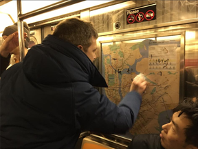 New Yorkers erase hateful graffiti from a subway train in Manhattan