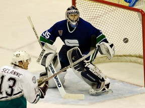 In this April 10, 2006 file photo, Vancouver Canucks goaltender Alex Auld (right) eyes the puck against Teemu Selanne of the Anaheim Mighty Ducks.