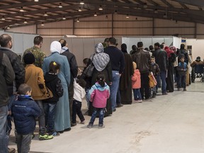 Syrian refugees line up at the processing centre in Amman, Jordan, where they will meet with Immigration, Refugee and Citizenship Canada (IRCC) employees on Dec. 13, 2015.