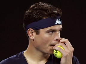 In this Jan. 25 file photo, Milos Raonic grabs a ball while playing Rafael Nadal in an Australian Open quarter-final.